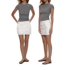 The grey Essential Tee worn with a white mini skirt and sandals