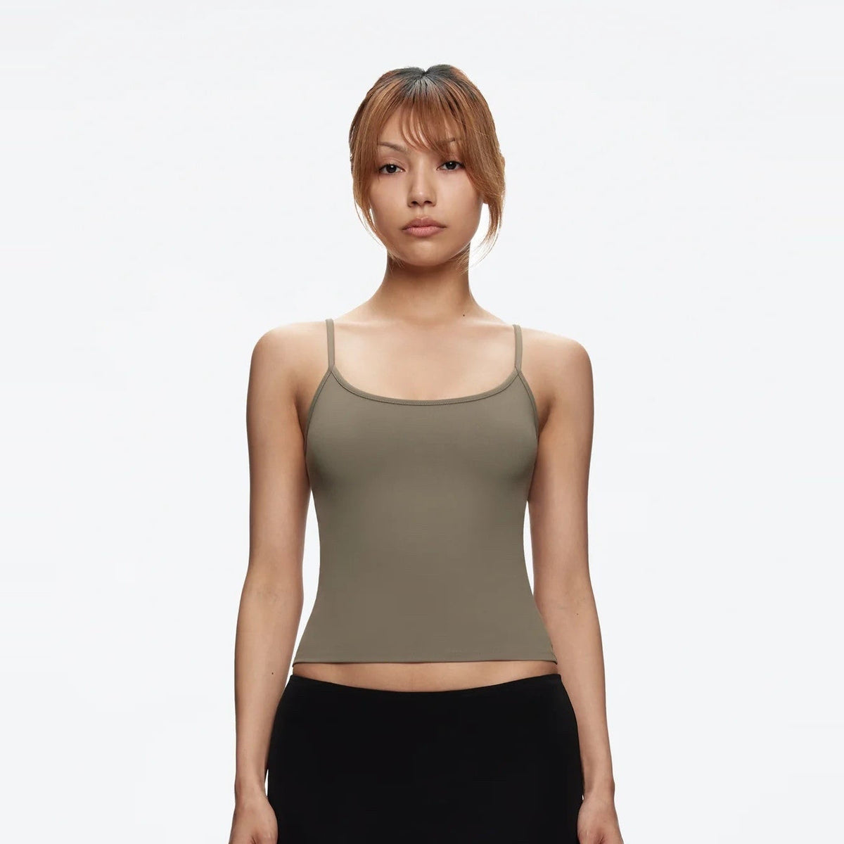 Front view of the Studio Tank in taupe, worn with a black skirt
