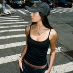 The black Studio Tank worn outdoors with a denim cap and dark jeans