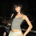 Side view of the sage grey Studio Tank worn with pale cargo trousers