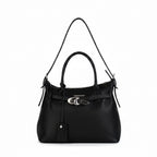 The Signature Tote carried on the shoulder strap